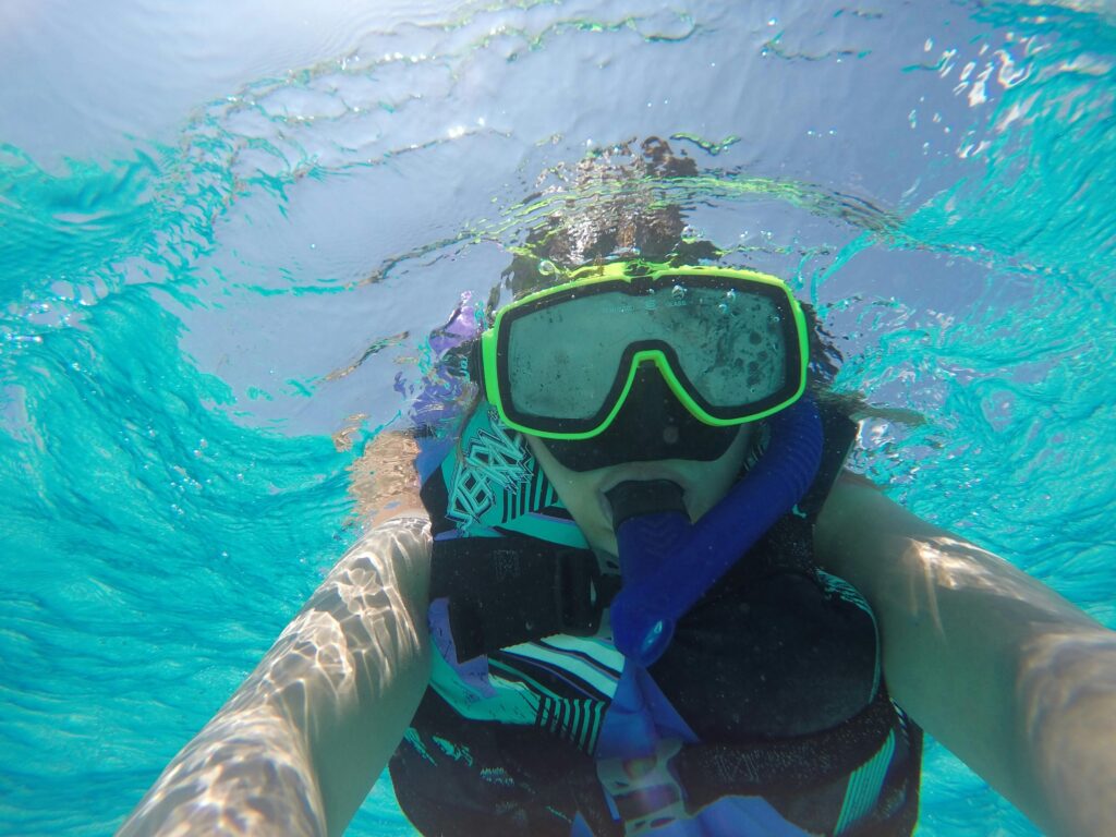 pexels photo 11215016 11215016 Snorkeler explores vibrant blue waters of Cayman Islands.